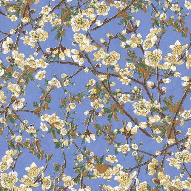 Japanese screen printed decorative chiyogami paper used in handmade cards. A repeating floral pattern featuring white blossoms and green leaves on brown branches against a light blue background.