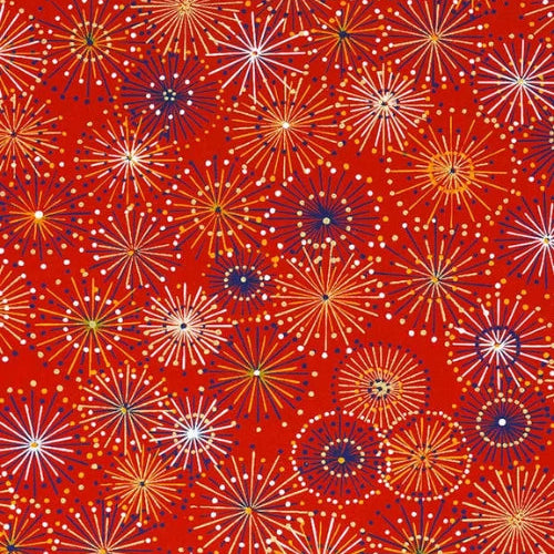 Japanese screen printed decorative chiyogami paper used in handmade cards. A repeating pattern of colorful fireworks or starburst motifs on a bright red background, with white, yellow, orange, and dark blue circular bursts.