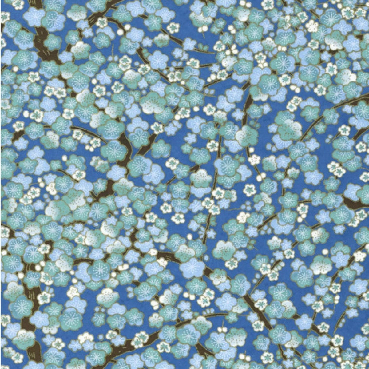 Japanese screen printed decorative chiyogami paper used in handmade cards. A repeating floral pattern featuring light blue and white blossoms with dark brown branches on a medium blue background.