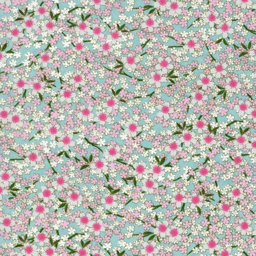 Japanese screen printed decorative chiyogami paper used in handmade cards. A repeating floral pattern featuring small white blossoms with bright pink centers and green leaves on a light blue background.