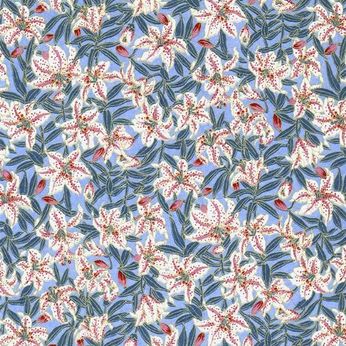 Japanese screen printed decorative chiyogami paper used in handmade cards. A repeating floral pattern featuring white lilies with red centers and blue-green leaves on a light blue background. 